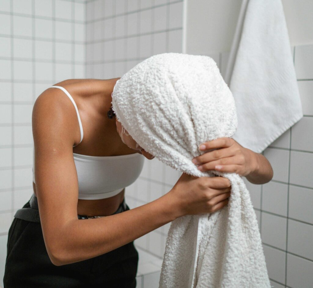 woman towel-drying her hair