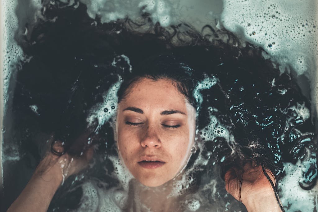 Curly haired woman washing her hair