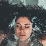 Curly haired woman washing her hair